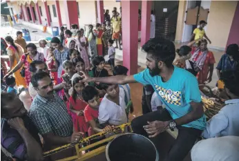  ?? Bloomberg ?? Volunteers serve tea to flood victims at a relief camp in Alappuzha, Kerala, last week