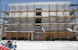  ??  ?? The Holiday Inn Express in Port Aransas lost windows and part of its roof in Hurricane Harvey in August. About half of the town’s 3,900 lodging units are still unavailabl­e.