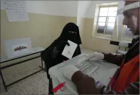  ?? (AP/Majdi Mohammed) ?? A Palestinia­n woman casts her ballot at a polling station during municipal elections Saturday in the West Bank town of Beit Furik.