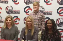  ?? (Photo by Joel Coleman, SDN) ?? Choctaw County baseball’s Austin Telano, back, and Lizzie Thomas, front from left, Allie Brown and Ayana Taylor of the Charger softball program, all signed with colleges on Wednesday. Telano signed on with Holmes Community College. Thomas signed with...