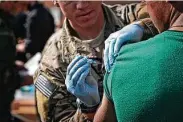  ?? Army Sgt. Matthew Freire / Washington Post file photo ?? An Afghan soldier receives a routine vaccinatio­n in 2013 from a coalition force member as part of the redeployme­nt process.