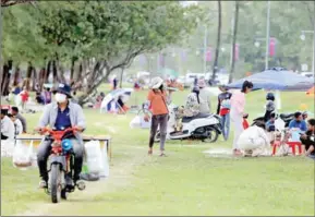  ?? HONG MENEA ?? People enjoy street food along the coast in Sihanoukvi­lle on December 30.