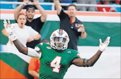  ?? [WILFREDO LEE/THE ASSOCIATED PRESS] ?? Miami’s Jeff Thomas celebrates after scoring during the Hurricanes’ victory against Syracuse on Saturday.