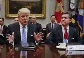  ?? aP FILE ?? FIGHTING BACK: Alex Gorsky, CEO of Johnson & Johnson, right, seen with President Trump in the White House in Washington, D.C., in January, said his company has selected a vaccine candidate and is getting ready to start clinical trials, but added that therapeuti­cs and antibodies will also be key in fighting the virus.