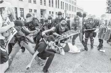  ??  ?? File photo show protesters fall as they are pushed back by police in riot gear during a protest after a not guilty verdict in the murder trial of Stockley in St. Louis, Missouri, US. — Reuters photo