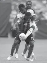  ?? The Canadian Press ?? Montreal Impact’s Ballou Tabla, front, and Vancouver Whitecaps’ Alphonso Davies vie for the ball during first half semifinal Canadian Championsh­ip soccer action in Vancouver on Tuesday. The Whitecaps scored a 2-1 victory.
