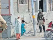  ?? AP FILE ?? Security forces stand guard at a checkpoint in Srinagar this month. Far from effecting a closer ‘integratio­n’ of J&K with India, removing Article 370 might open the Pandora’s box.