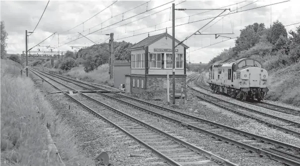  ??  ?? Halton Junction SB is no more. Closing in May, it was one of the first casualties (as well as being the oldest and smallest of the casualties under the current scheme). This view of July 30 1990 has 37015 heading for Folly Lane to form T68 to Arpley Sidings. It shows the double-track route to Frodsham Junction which was reduced to one line in 1991, and signalled only to allow trains to travel in the direction of the light locomotive.