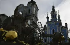  ?? Associated Press ?? Destroyed domes lie next to a damaged church Saturday in the retaken village of Bohorodych­ne, eastern Ukraine.