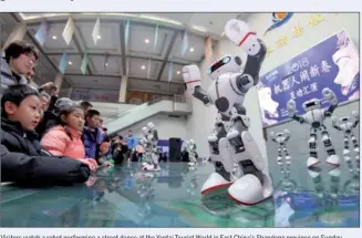  ?? TANG KE / FOR CHINA DAILY TANG KE / FOR CHINA DAILY ?? Visitors watch a robot performing a street dance at the Yantai Tourist World in East China’s Shandong province on Sunday. Visitors watch a robot performing a street dance at the Yantai Tourist World in East China’s Shandong province on Sunday.