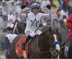  ?? MORRY GASH — THE ASSOCIATED PRESS ?? Mike Smith celebrates after riding Justify to victory during the 144th running of the Kentucky Derby at Churchill Downs on May 5.