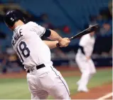  ?? KIM KLEMENT/USA TODAY SPORTS ?? Tampa Bay second baseman Joey Wendle hits an RBI single during the sixth inning against Toronto at Tropicana Field.