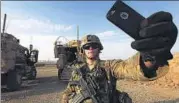  ?? REUTERS ?? An American soldier takes a selfie at the US Army base in Qayyara, south of Mosul, on Wednesday.