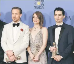  ??  ?? Ryan Gosling (left), Emma Stone and Damian Chazelle pose together after ‘La La Land’ won the award for Best Motion Picture - Musical or Comedy, as well as individual awards for Best Performanc­e by an Actor in a Motion Picture - Musical or Comedy for Gosling, Best Performanc­e by an Actress in a Motion Picture - Musical or Comedy for Stone and Best Director - Motion Picture for Chazelle, during the Golden Globe Awards.