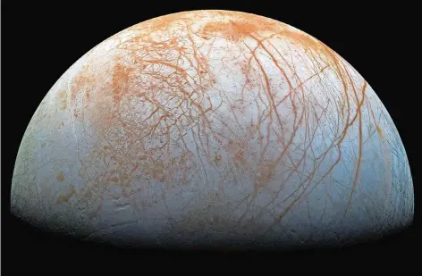  ?? FOTO: NASA ?? Den Jupitermon­d Europa hat fast keine Krater. Stattdesse­n überzieht ein riesiges Netz von Spalten und Brüchen seine Oberfläche.