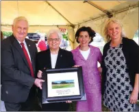  ?? Ernest A. Brown photo ?? From left, Cumberland Mayor William S. Murray is pictured with Sister Jacqueline Marie Kieslich, RSM, President, Sisters of Mercy of the Americas Northeast Community, Governor Gina Raimondo, and Janet Coit, Director, Rhode Island Department of Environmen­tal Management, with a framed commemorat­ive photograph of Mercy Woods following a dedication ceremony there Monday. Mayor Murray presented each of the partners involved in the agreement to purchase 229 acres of open space with a framed picture during the ceremony.