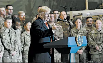  ?? OLIVIER DOULIERY/GETTY-AFP ?? President Trump speaks to U.S. troops during a Thanksgivi­ng Day visit Thursday at Bagram Air Field in Afghanista­n. Next, he’s scheduled to be received by Queen Elizabeth II.