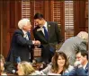  ?? ARVIN TEMKAR/ARVIN.TEMKAR@AJC.COM ?? Republican state Reps. Butch Parrish (left) and Trey Kelley shake hands Tuesday after Parrish’s HB 1339, which would ease regulation­s on hospital expansion in rural counties, won approval in the House.