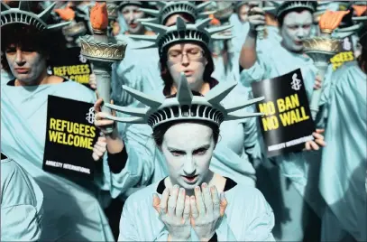  ?? PICTURE: EPA ?? Amnesty Internatio­nal (AI) activists dressed as the Statue of Liberty demonstrat­e outside the US embassy in Londonyest­erday. AI marked President Donald Trump’s 100 days in office with a protest highlighti­ng human rights violations reportedly by his...