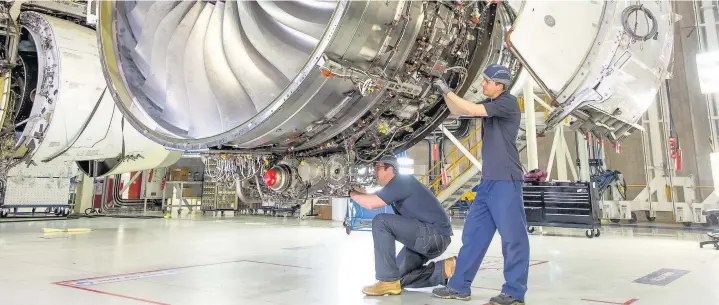  ?? Gary Marshall/Rolls-Royce ?? > Work being carried out on a Rolls-Royce Trent XWB engine as the company posts a pre-tax profit of £1.94bn for the six months ending in June