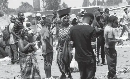  ?? TSVANGIRAY­I MUKWAZHI/AP ?? People at a market Nov. 15 near Harare, Zimbabwe. Much of Africa appears not to have been affected by the coronaviru­s pandemic.