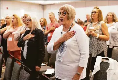  ?? Rebecca S. Gratz / Associated Press ?? Robbie Adams of Sarpy County, Neb., recites the Pledge of Allegiance with fellow attendees to open the Nebraska Election Integrity Forum on Aug. 27 in Omaha, Neb.