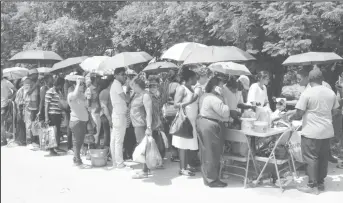  ??  ?? Some of those who travelled to Lusignan yesterday with food and clothing for their relatives currently housed at the Lusignan Prison.