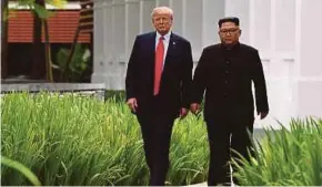  ??  ?? United States President Donald Trump walking with North Korea’s leader, Kim Jong-un, during a break in talks at a summit in Singapore earlier last year.