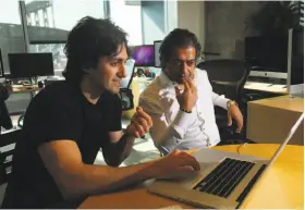  ?? Jim Wilson / New York Times 2011 ?? Babak Nivi (right) and Naval Ravikant, co-founders of AngelList, work in their San Francisco office in 2011. Nivi recently left the firm’s board.