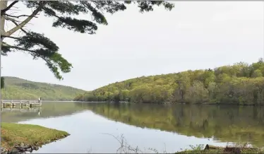  ?? Alexander Soule / Hearst Connecticu­t Media ?? Squantz Pond in New Fairfield, with the wooded neck on the right where Camp Candlewood has been put up for sale in April 2021 for nearly $10 million, with the possibilit­y of redevelopm­ent of its 87 acres.