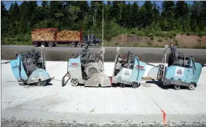  ??  ?? A row of concrete saws sit on concrete lanes that were poured in 2003 on a stretch of Highway 101, near St. Croix.