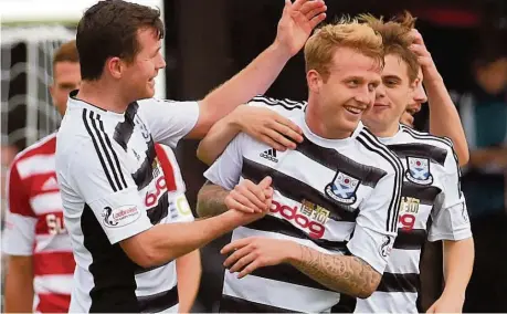  ??  ?? TOP GUN Robbie Crawford (centre) takes the praise after extending Ayr United’s lead with a fine 20-yard curling shot