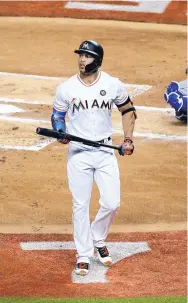  ?? WILFREDO LEE/ASSOCIATED PRESS ?? Miami’s Giancarlo Stanton walks off the field after striking out in the first inning of the All-Star Game on Tuesday. There were 22 strikeouts in the game.