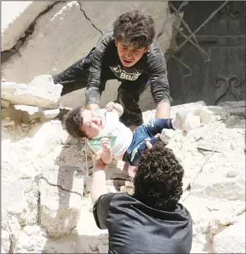  ??  ?? Syrians evacuate a toddler from a destroyed building following a reported air strike on the rebel-held neighbourh­ood of
al-Kalasa in the northern Syrian city of Aleppo, on April 28. (AFP)