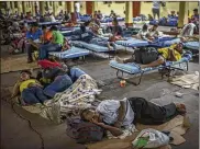  ?? DANIELE VOLPE / THE NEW YORK TIMES ?? Honduran migrants rest Wednesday at a church-run shelter in Guatemala City. A caravan of about 4,000 people is heading north.