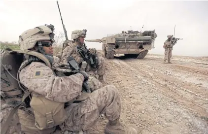  ?? AFP ?? In this file photo, US marines patrol past a Danish army Leopard 2A5EK tank as they clear Improvised Explosive Devices (IEDs) from a main route in Trikh Nawar on the northeaste­rn outskirts of Marjah, Afghanista­n, on Feb 21, 2010.