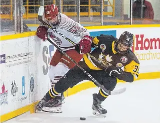  ?? JULIE JOCSAK TORSTAR ?? St. Catharines’ Brady Caruso (55) and Niagara Falls’ Max Lightfoot battle for possession in Jr. B hockey action at Jack Gatecliff Arena in St. Catharines.