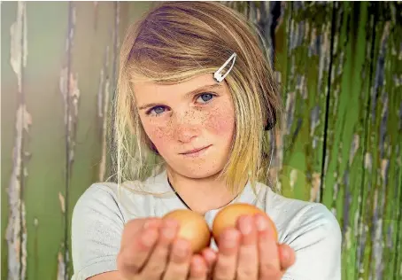  ?? PHOTO: DAVID UNWIN/STUFF ?? Ava Thomas with eggs from her chooks.