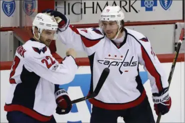  ?? GENE J. PUSKAR — ASSOCIATED PRESS ?? The Capitals’ Kevin Shattenkir­k (22) celebrates with T.J. Oshie against the Penguins in Pittsburgh. The Lifeguard Financial/ Pepco men’s softball team recently took second place in the Heart of Ohio 70AAA