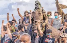  ?? ANTHONY JACKSON/JOURNAL ?? Amid a push to rid the public sphere of memorials to racist and oppressive figures, protesters convened at the city’s “La Jornada” sculpture, which includes a statue of conquistad­or Juan de Oñate.