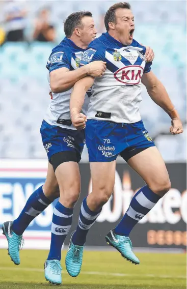  ??  ?? SEEING DOUBLE: Josh Morris (right) celebrates with brother Brett (left) after scoring a try.