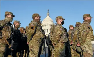  ?? WASHINGTON POST ?? Members of the Pennsylvan­ia National Guard line up outside the United States Capitol yesterday in Washington DC.