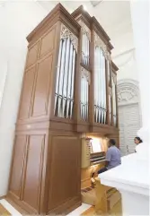  ??  ?? Leonard Silva playing on the new pipe organ during Sunday service.