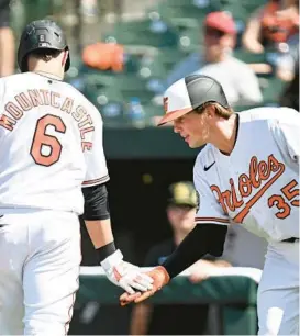  ?? GETTY GREG FIUME/ ?? The Orioles’ Ryan Mountcastl­e celebrates with Adley Rutschman (35) after hitting a home run in the fifth inning against the Rays at Oriole Park at Camden Yards on Sunday.