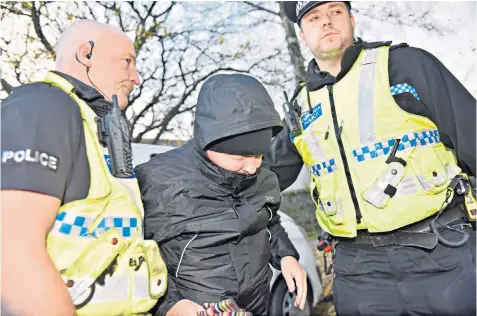  ??  ?? Police lead Paul Worthingto­n to the doors of the coroner’s court in Kendal, Cumbria, yesterday. He refused to answer dozens of questions put to him by coroner and counsel