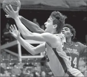  ?? Submitted photo ?? TO THE HOOP: UCA junior guard Thatch Unruh, front, puts up a shot past 6-8 Texas A&M-Corpus Christi Islanders redshirt freshman forward York Benjamin Thursday afternoon at the Farris Center in Conway. Unruh’s career-high 20 points led the Bears in...