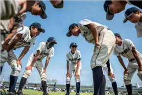  ?? AFP/VNA Photos ?? HUDDLE: High school baseball is closely followed in Japan.
