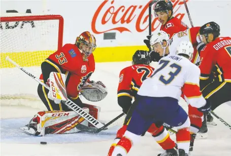  ?? PHOTOS: AL CHAREST ?? Calgary Flames goalie David Rittich makes a save against the Florida Panthers Thursday as the hosts won 6-5 in a shootout.