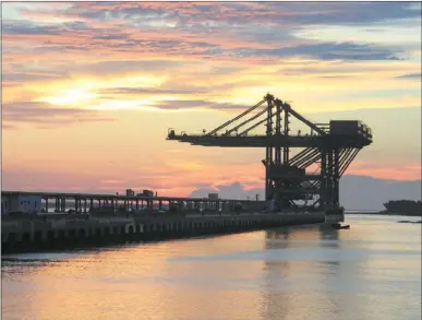  ?? WANG JIANGUO / FOR CHINA DAILY ?? A 300,000-ton raw material wharf is under constructi­on for the Baosteel facility in Zhanjiang.