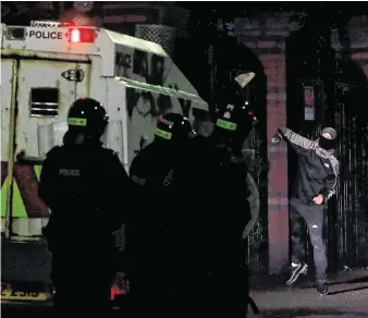  ?? PHOTO: BRIAN LAWLESS/PA ?? Unrest: A Loyalist rioter attacks police in north Belfast during further unrest in Northern Ireland.